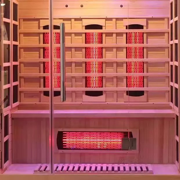 Illuminated 6-10 person hybrid sauna at dusk